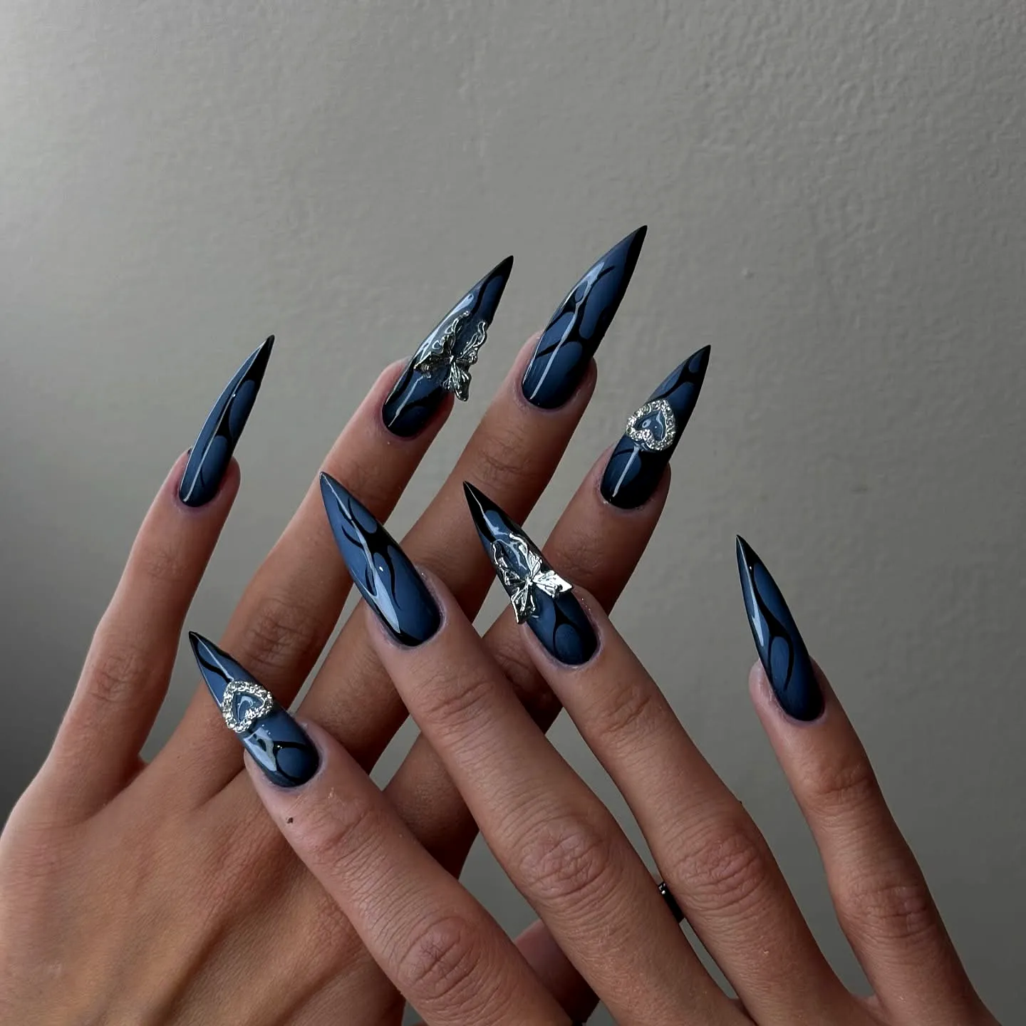 Chic Stiletto Dark Wedding Nails with Intricate Silver Embellishments and Glossy Abstract Designs