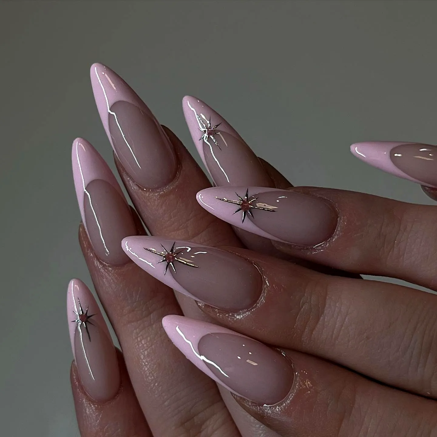 Chic Stiletto Pink Birthday Nails with Glossy Nude Base and Silver Star Accents
