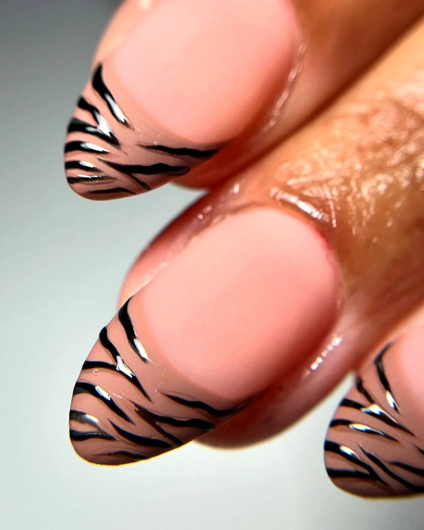 Chic Stiletto Zebra Print Nails with Nude Base and Bold Black Stripes