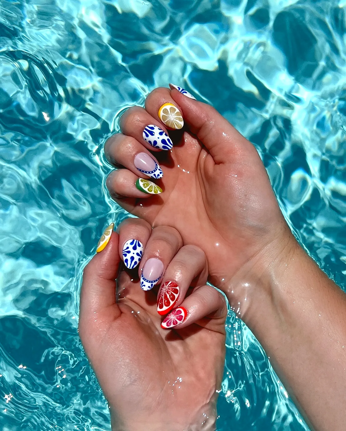 Cute Almond and Rounded Beach Nails in Bright Blue and White with Tropical Fruit Art