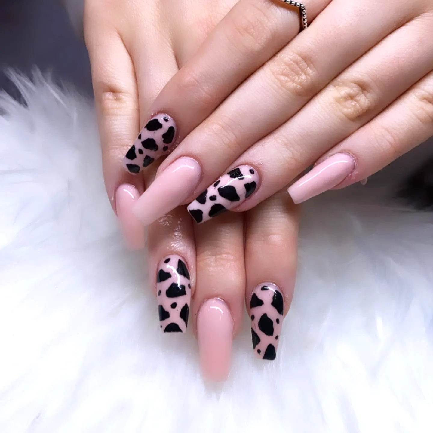 Cute almond and square fall nail designs with soft pink base and bold black leopard print accents