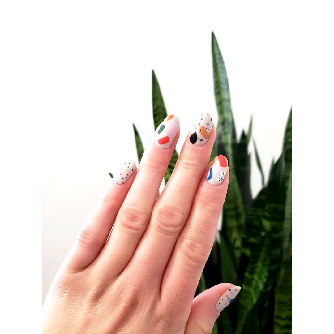 Cute almond-shaped geometric nail designs in pastel and bold colors with abstract art elements