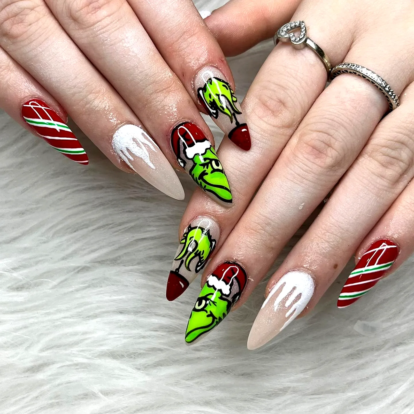 Cute Almond-Shaped Grinch Nails with Drip Effects and Festive Candy Cane Stripes