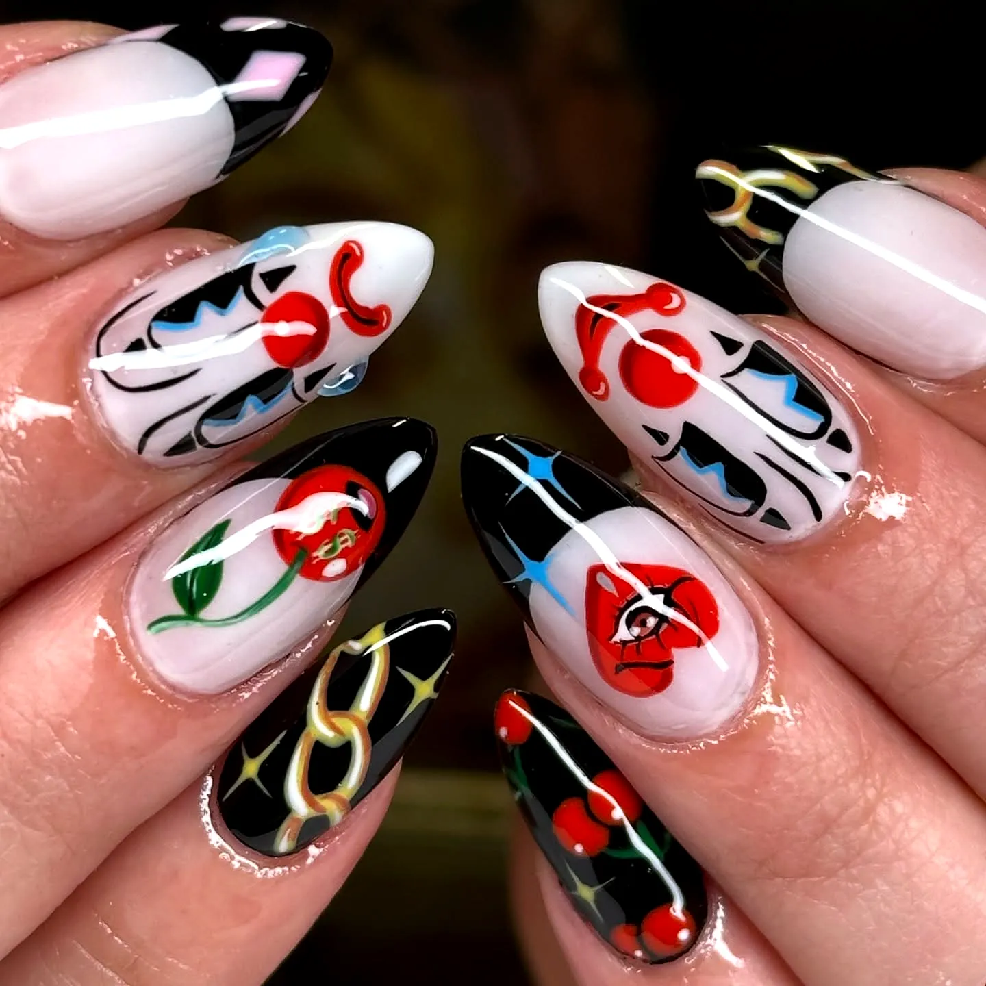Cute Almond-Shaped Halloween Nails for Kids Featuring Glossy Black and White Floral and Geometric Designs