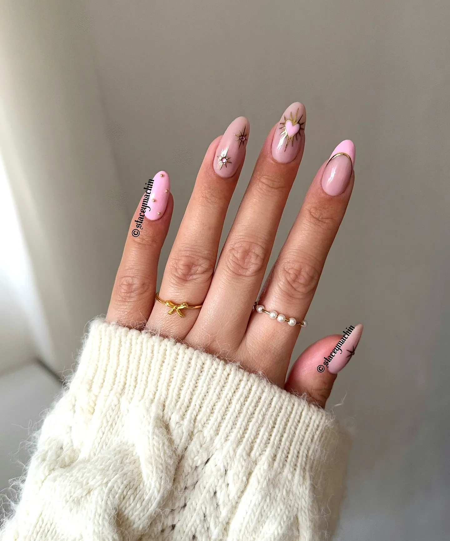 Cute almond shaped pink birthday nails with floral patterns and star accents