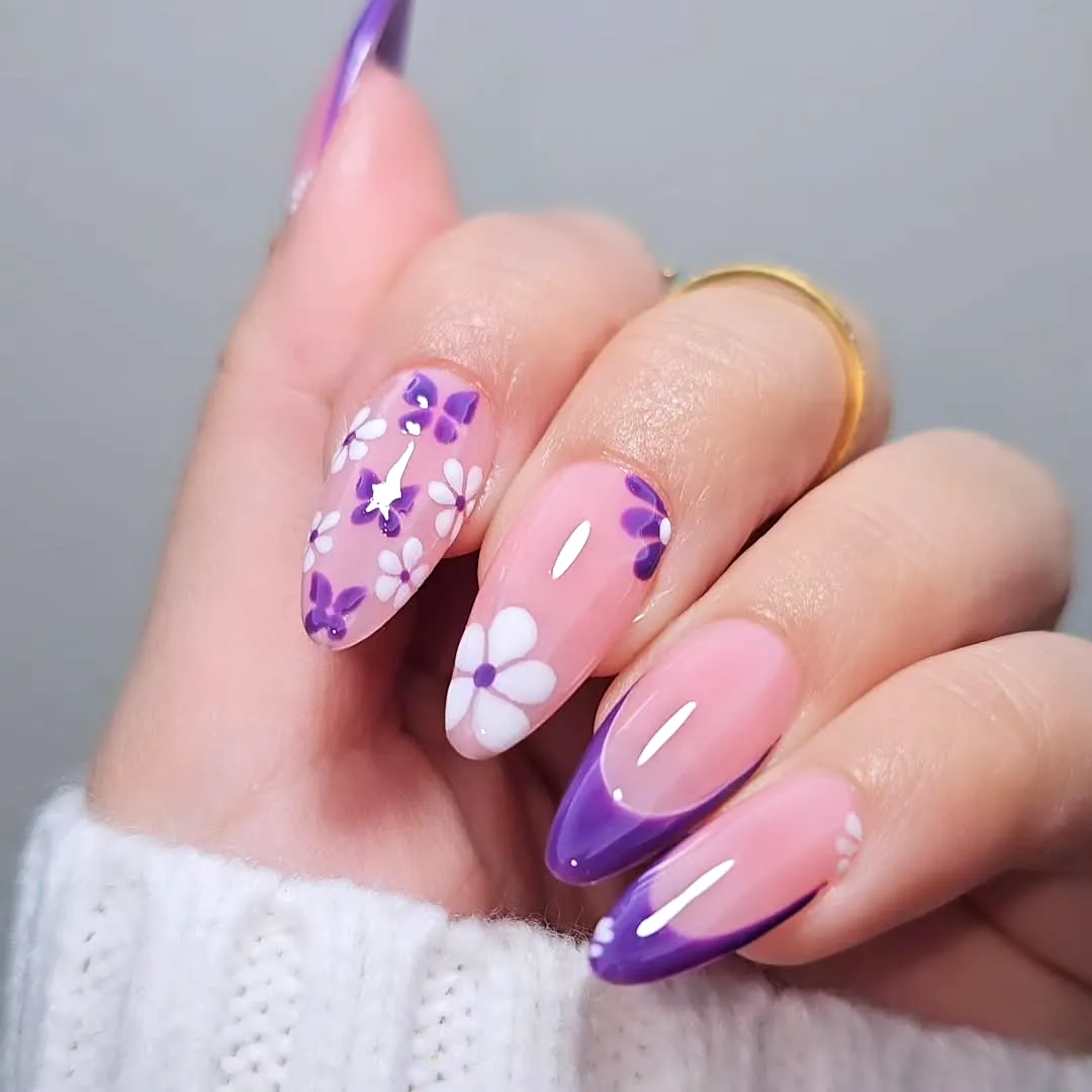 Cute almond-shaped purple nails with floral patterns and gradient tips