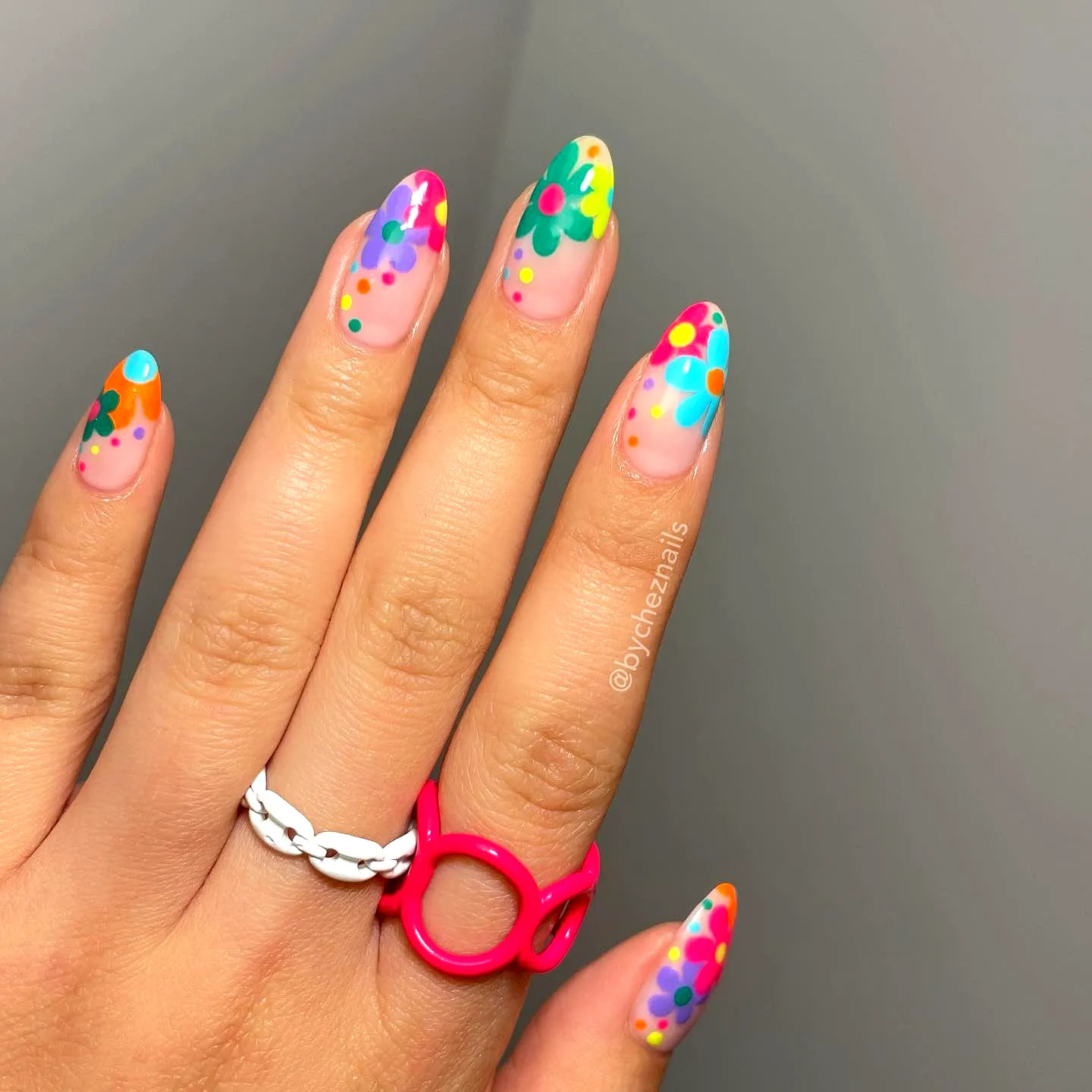 Cute almond shaped summer nail designs with colorful floral patterns and playful dots