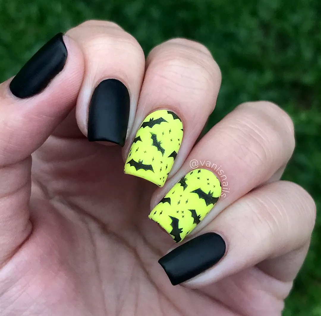 Cute coffin-shaped bat nail designs featuring neon yellow and black matte accents