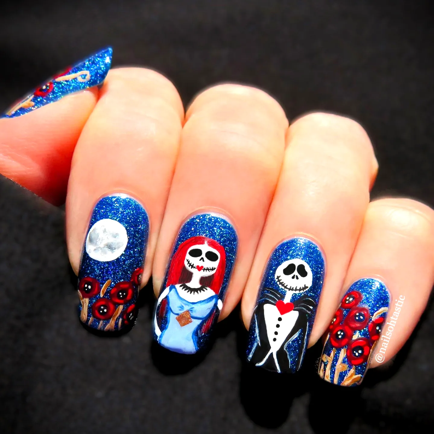 Cute glittery blue nightmare before christmas nails with intricate hand-painted characters and festive artistic style