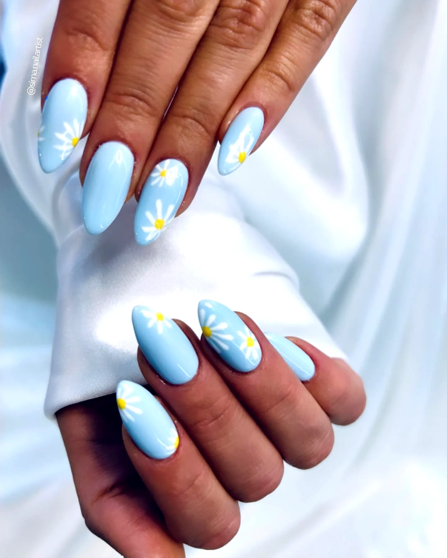 Cute pointed light blue summer nail designs with whimsical white daisy accents