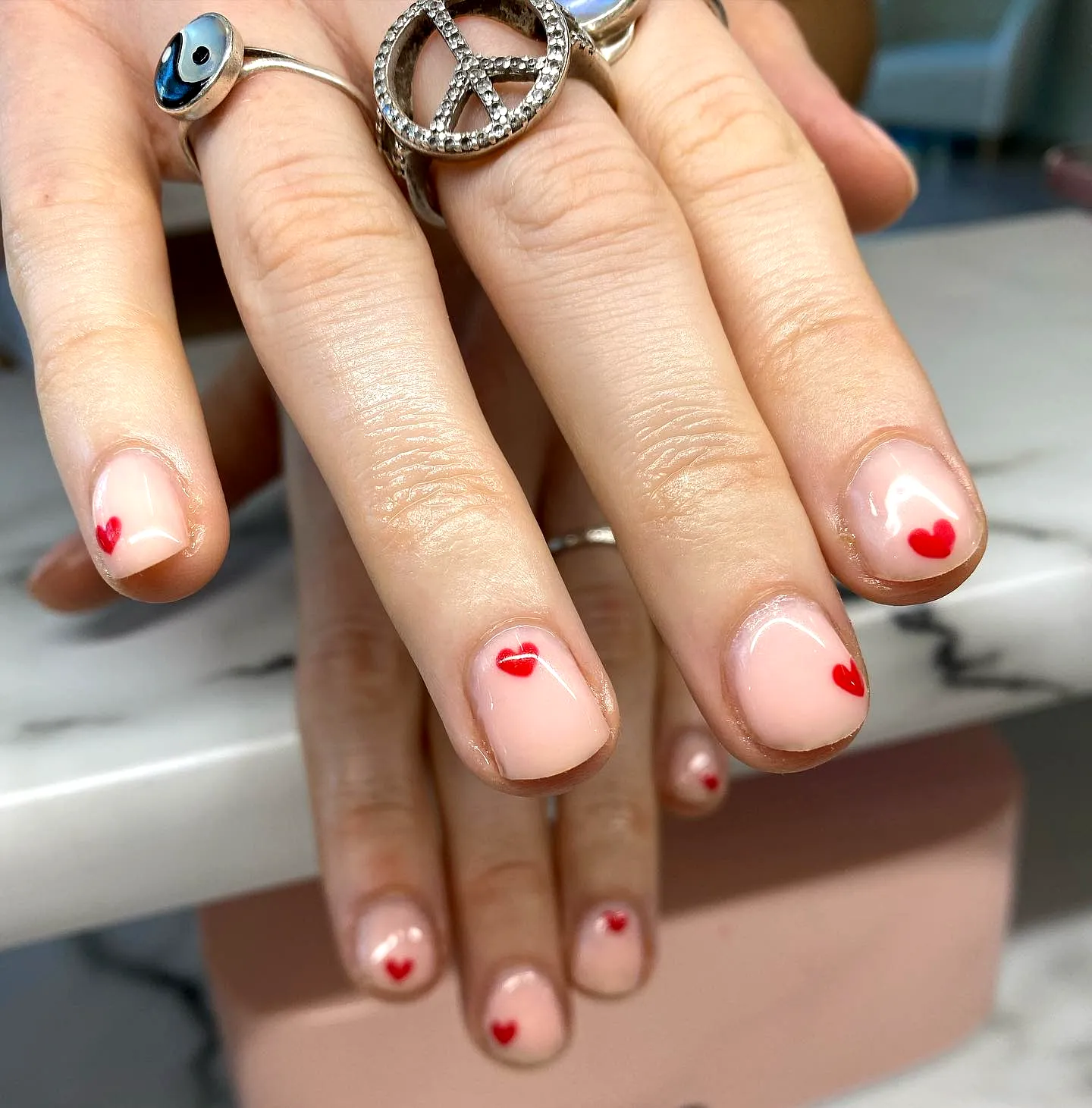 Cute Ring Finger Heart Nails with Natural Shape Nude Base and Minimalistic Red Heart Accents