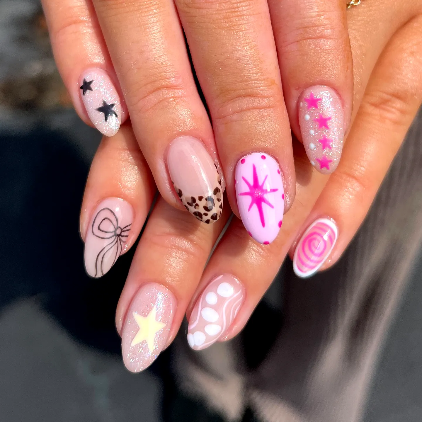 Cute Round Nails in Pink and Nude Featuring Glitter Stars Leopard Print and Playful Swirls