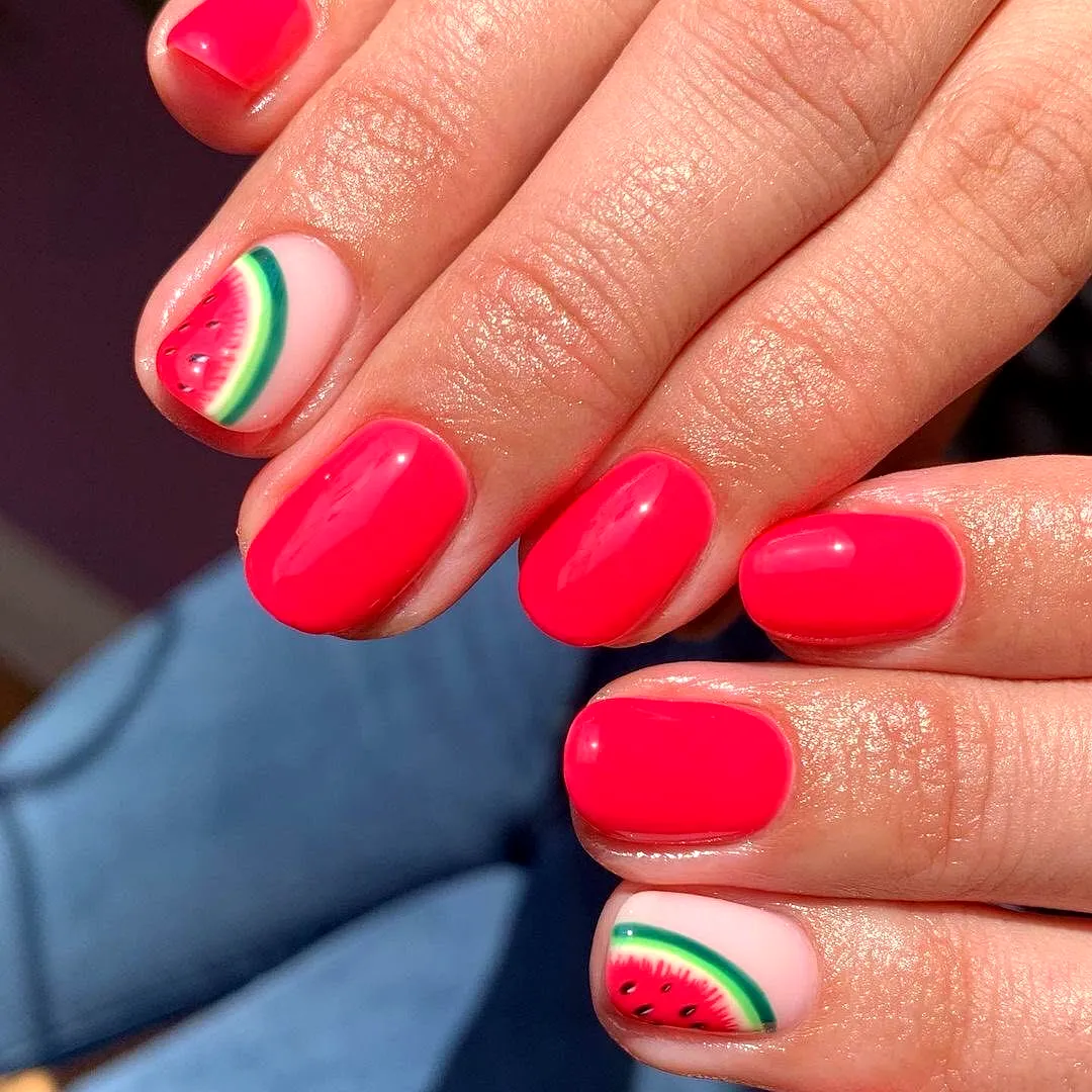 Cute rounded fruit nail designs with vibrant hot pink and playful watermelon accents