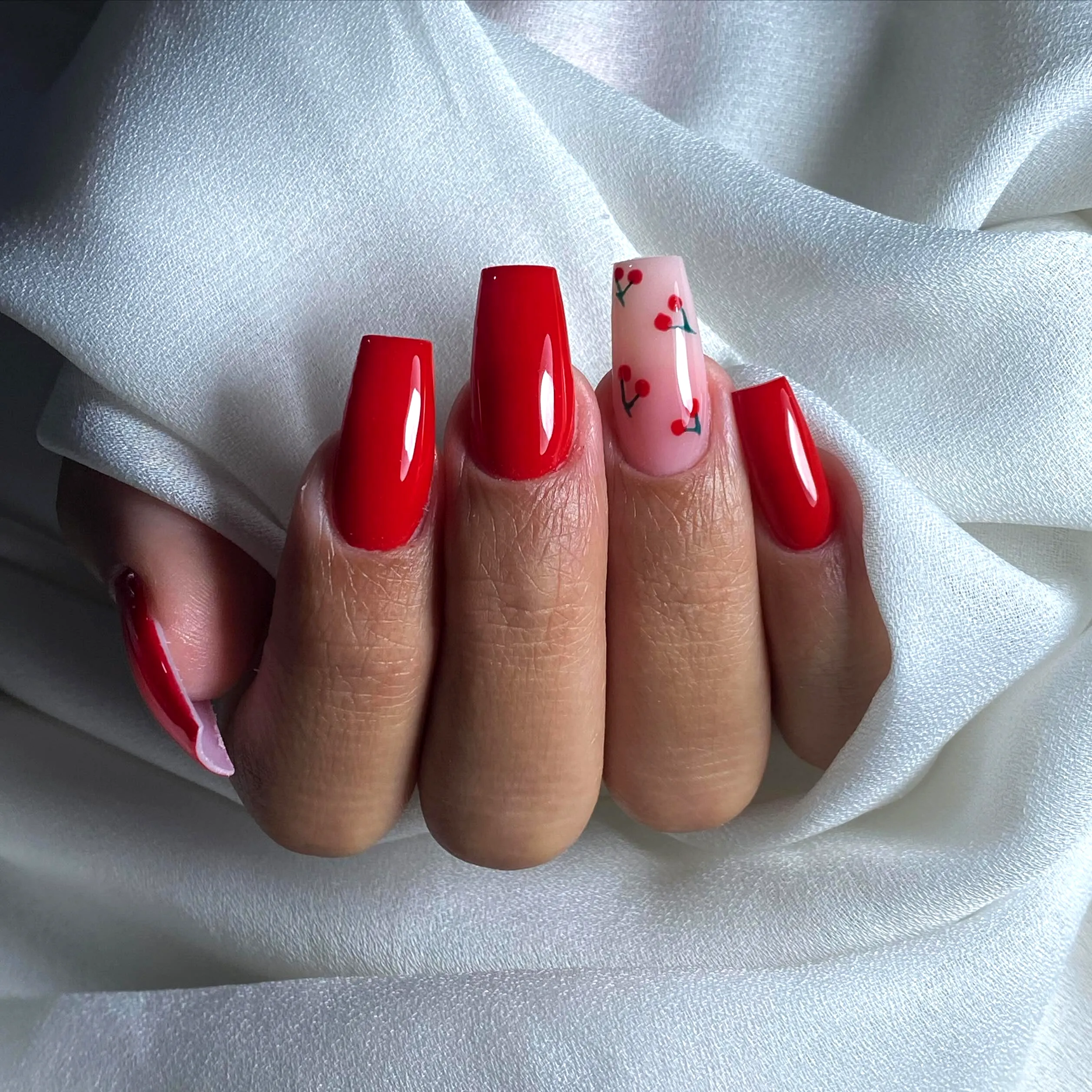 Cute Square Red Nails with Cherry Accent Art in a Playful Modern Style