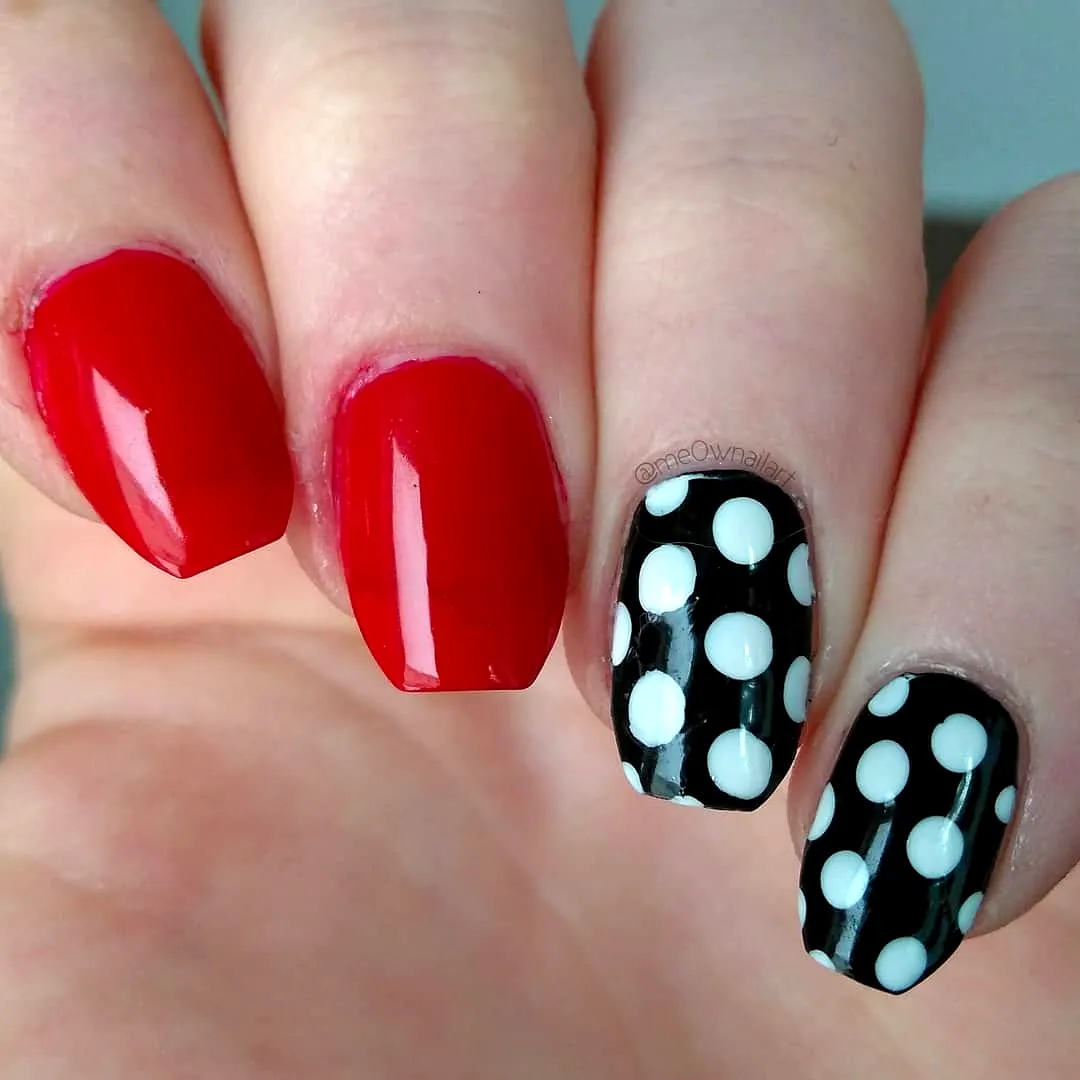 Cute square shaped nails with bold red color and playful black and white polka dot nails