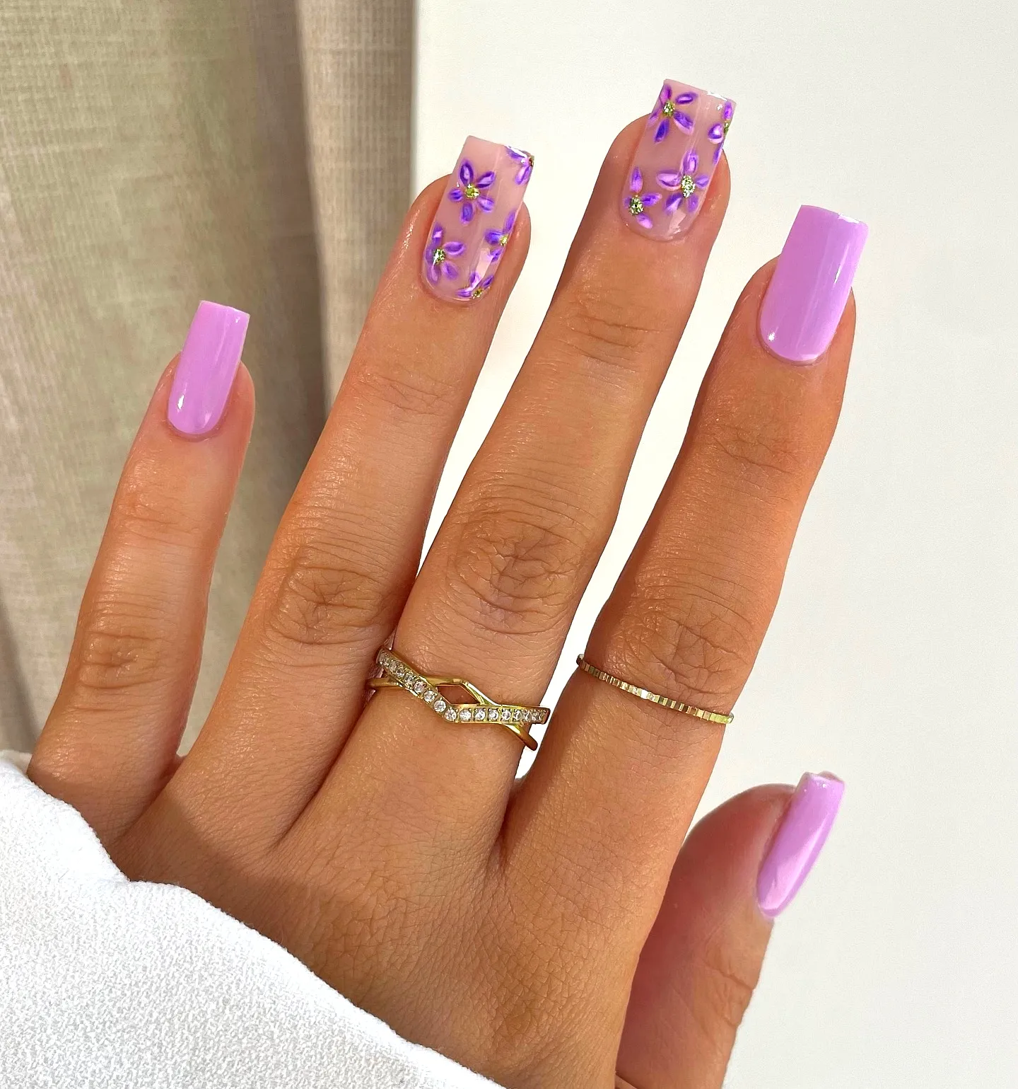 Cute square-shaped purple spring nails with pastel lavender base and floral art