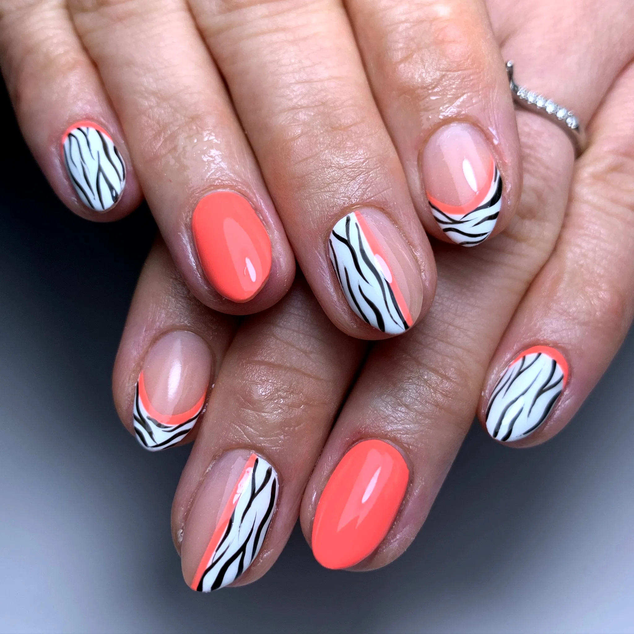 Cute Zebra Print Nails with Coral Pink and Nude Shades in a Modern Playful Style