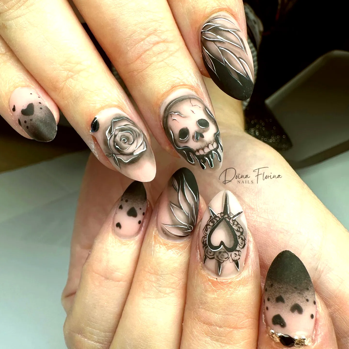 Edgy Stiletto Halloween Nails with Skull and Rose Art in Pink and Black Gradient