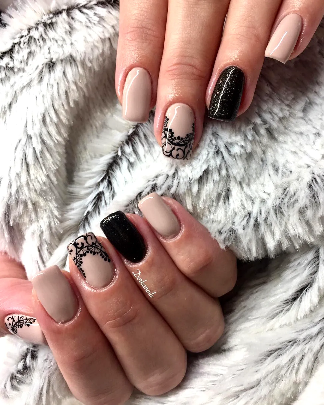 Elegant almond and square lace nails in nude with striking black lace and glittery accents