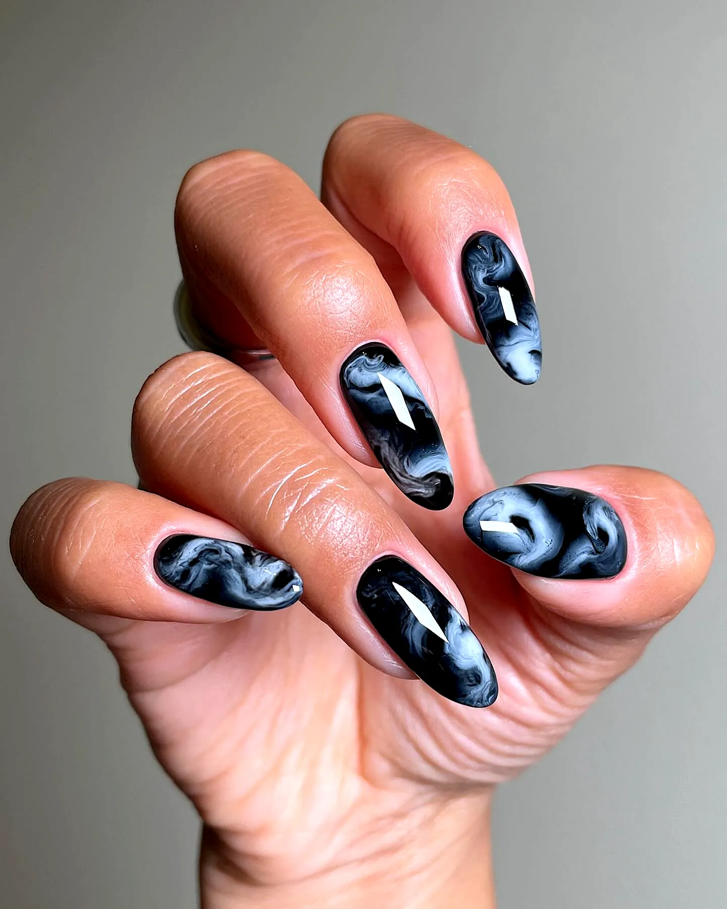 Elegant Almond Black Nails with Glossy Marbled Design