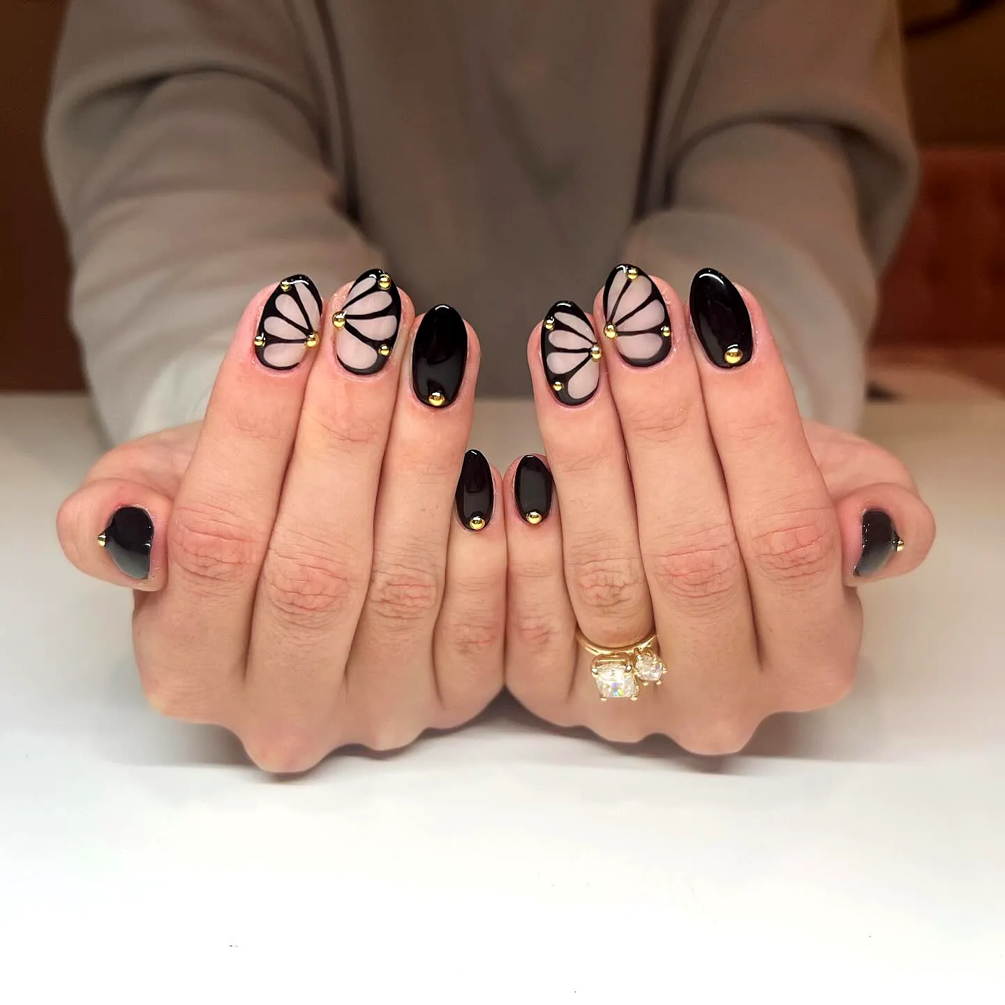 Elegant Almond Shaped Black Nails with Butterfly Wing Art and Gold Accents