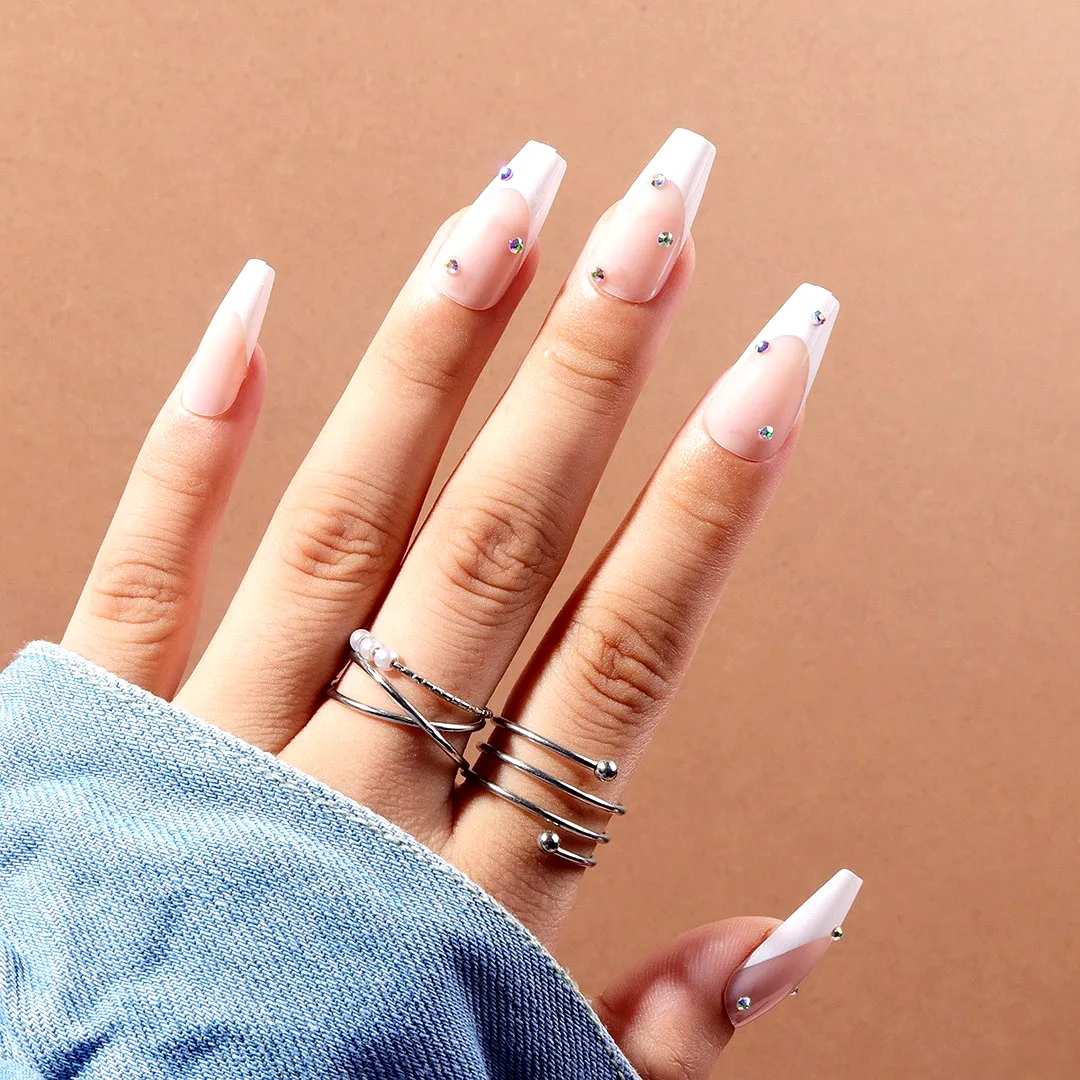Elegant almond-shaped classy nail designs with white French tips and sparkling rhinestones