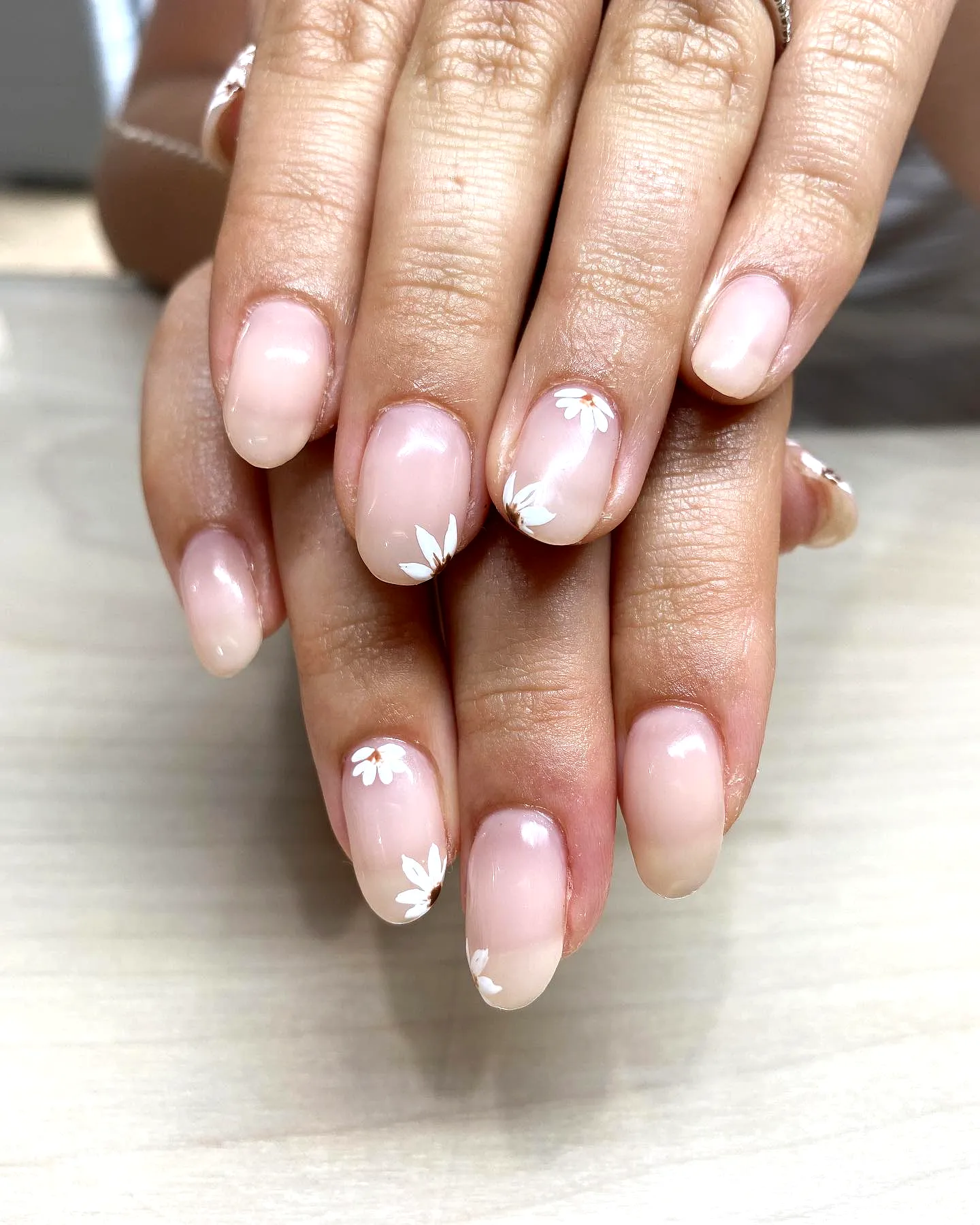 Elegant almond-shaped gothic easter nails with soft pink gradient and delicate floral patterns