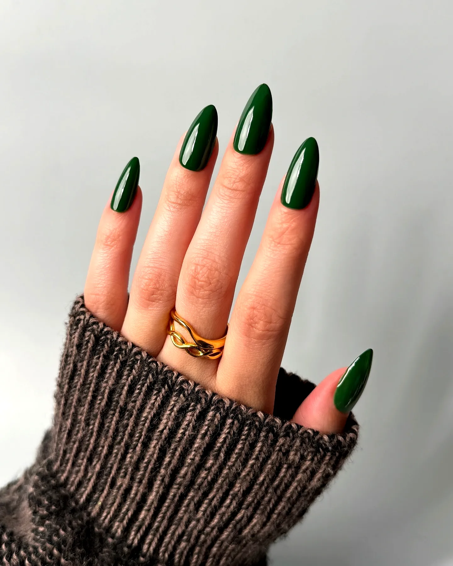 Elegant Almond-Shaped Green Nails with Gold Ring Accent