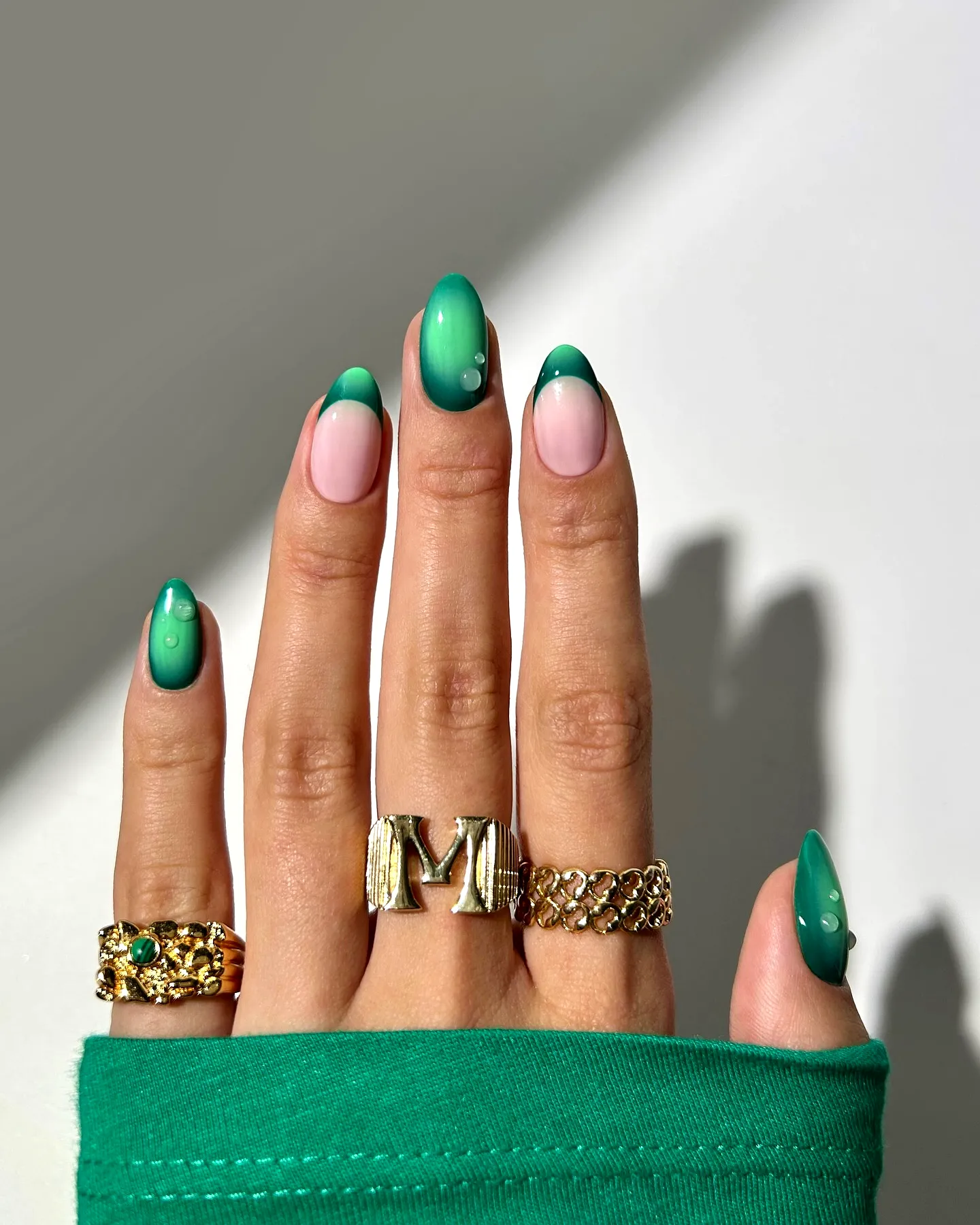 Elegant Almond Shaped Green Nails with Gradient Effect and Subtle Embellishments
