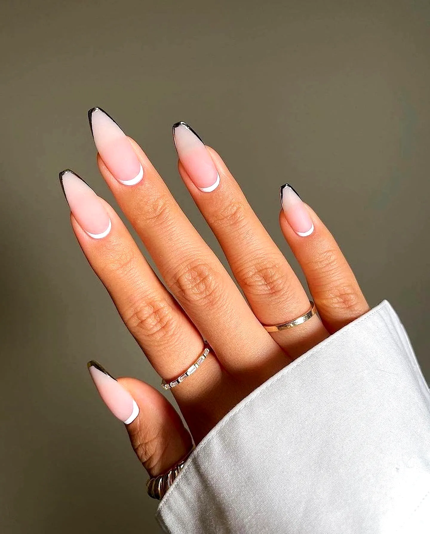 Elegant almond-shaped spring classy nails with soft pink ombre and striking black French tips