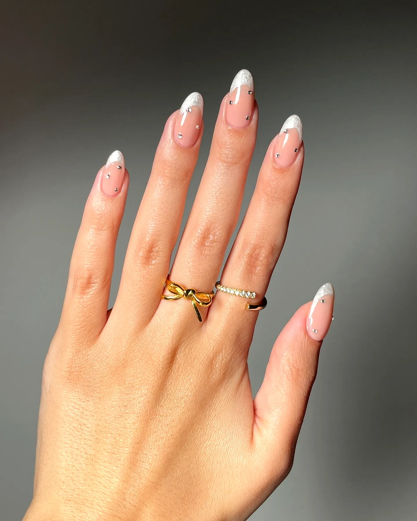 Elegant Almond Shaped Wedding Nails with Nude Base and Shimmering Silver French Tips