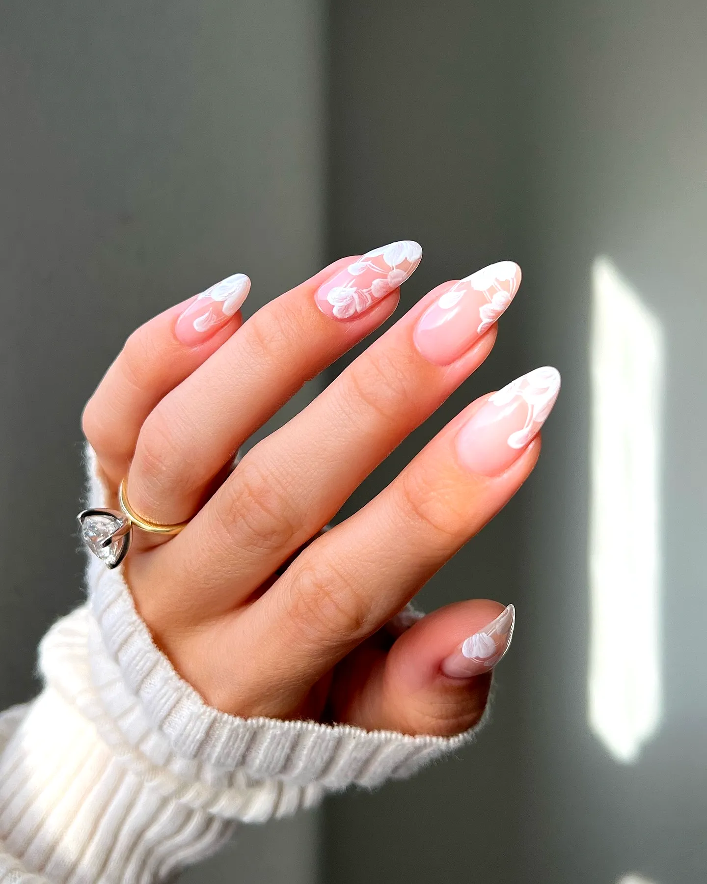 Elegant Almond-Shaped Wedding Nails with Translucent Base and White Floral Patterns