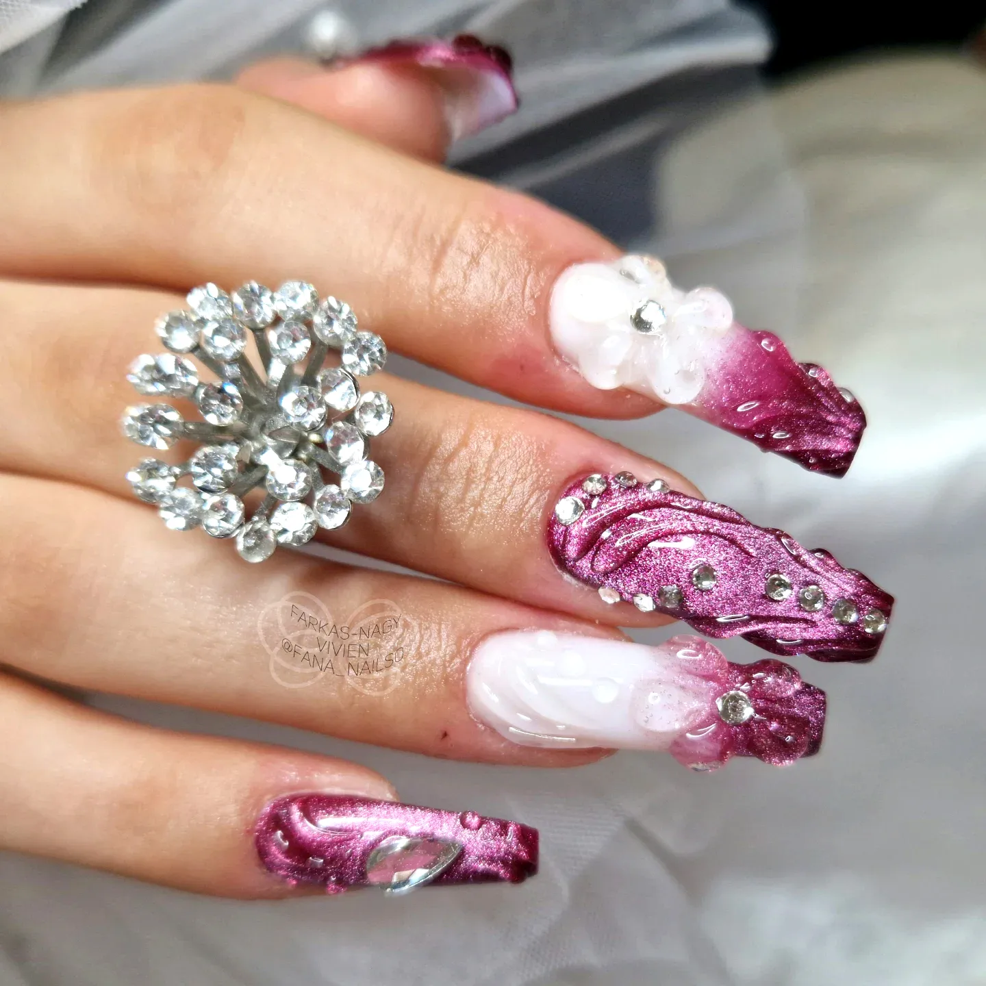 Elegant coffin ballerina nails in deep burgundy with floral designs and intricate swirling patterns
