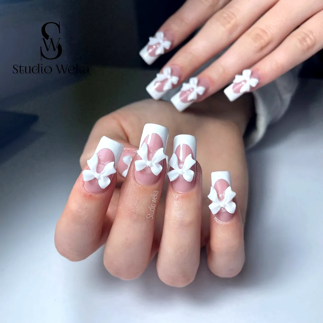 Elegant long square white French tip nails with 3D bows for classy spring nail art