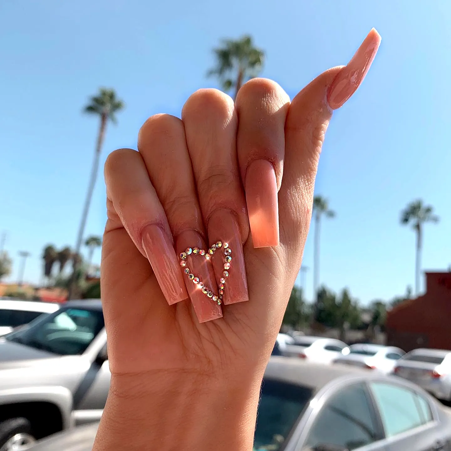 Elegant Peach Stiletto Rhinestone Nail Designs with Heart Detail