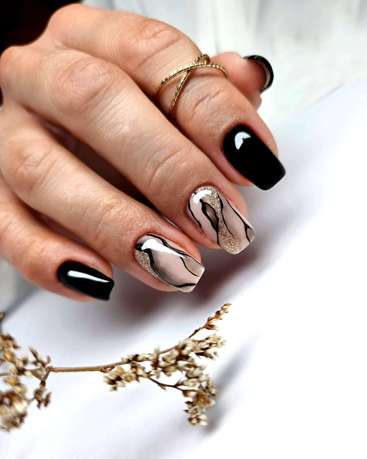 Elegant square black nails with artistic marble accents in pink and gold