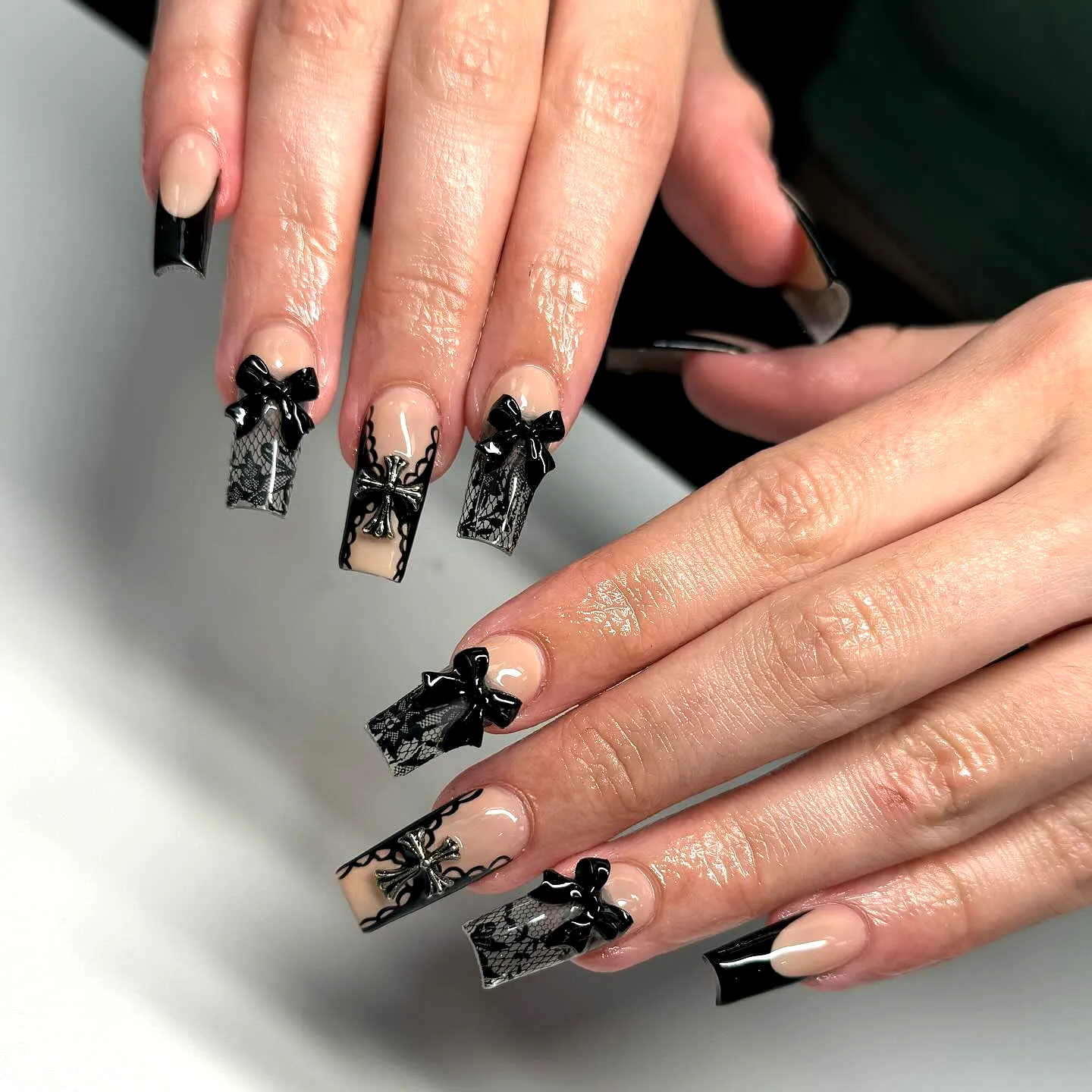Elegant Square Lace Nails in Black and Nude with Intricate Patterns and Bows