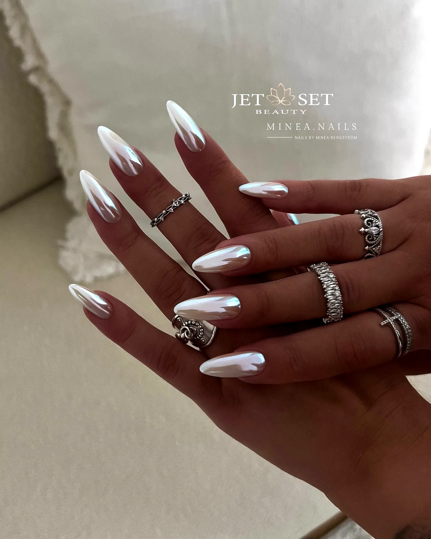 Elegant Stiletto Chrome Nails with Glossy White Base and Holographic Shine