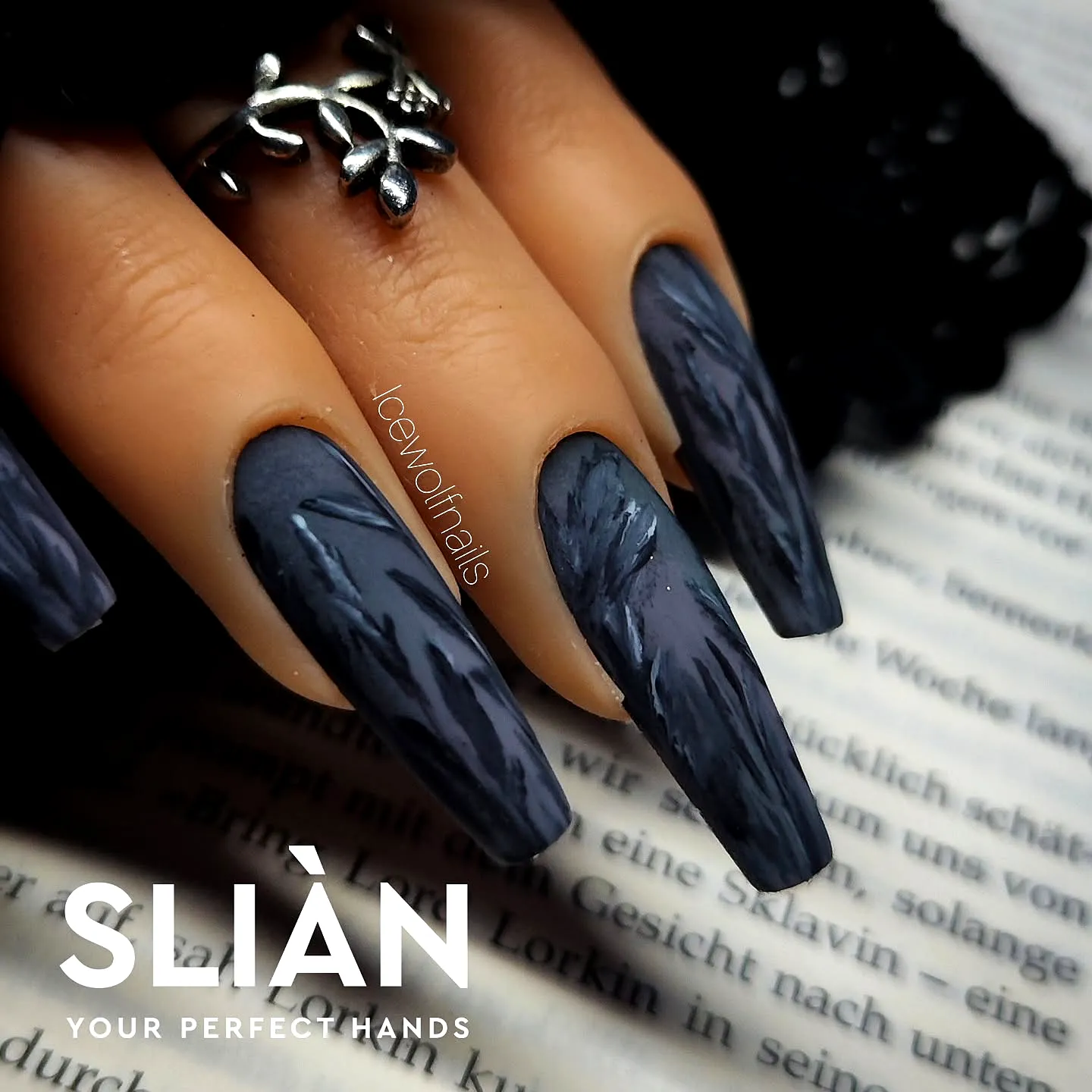 Elegant stiletto dark wedding nails in deep charcoal gray with textured abstract art