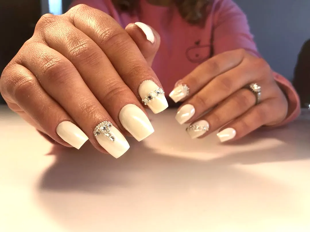 Elegant Stiletto Honeymoon Nails with Glossy White Finish and Glamorous Silver Rhinestones