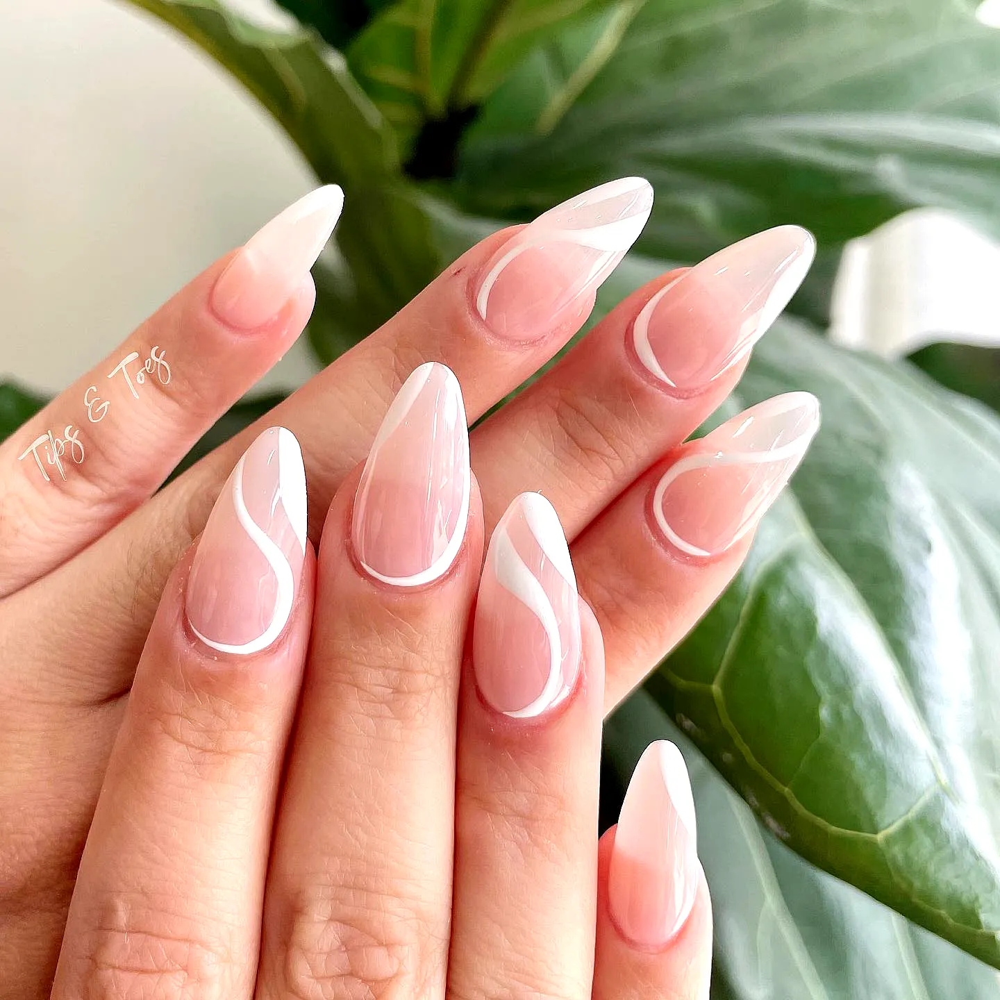 Elegant Stiletto Swirl Nail Designs in Soft Pink and White