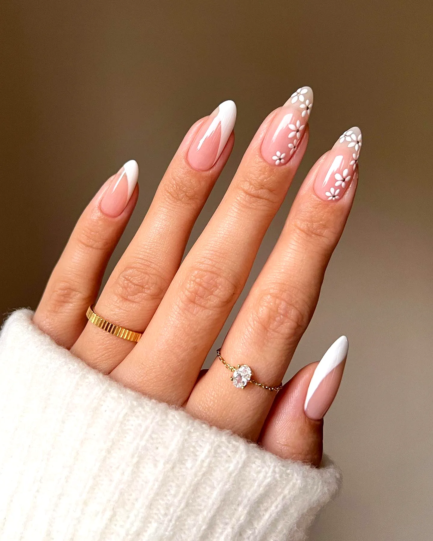 Elegant stiletto wedding nails with translucent base and white floral accents