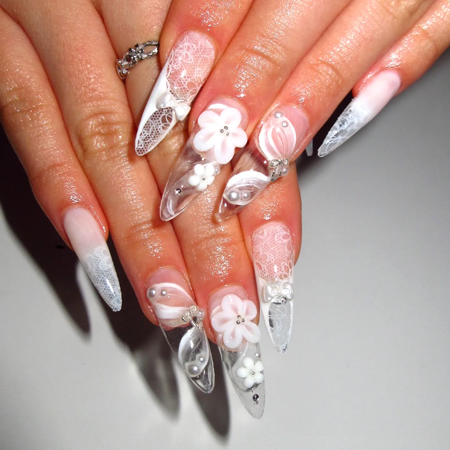 Elegant Stiletto White Nails with Floral and Lace Patterns