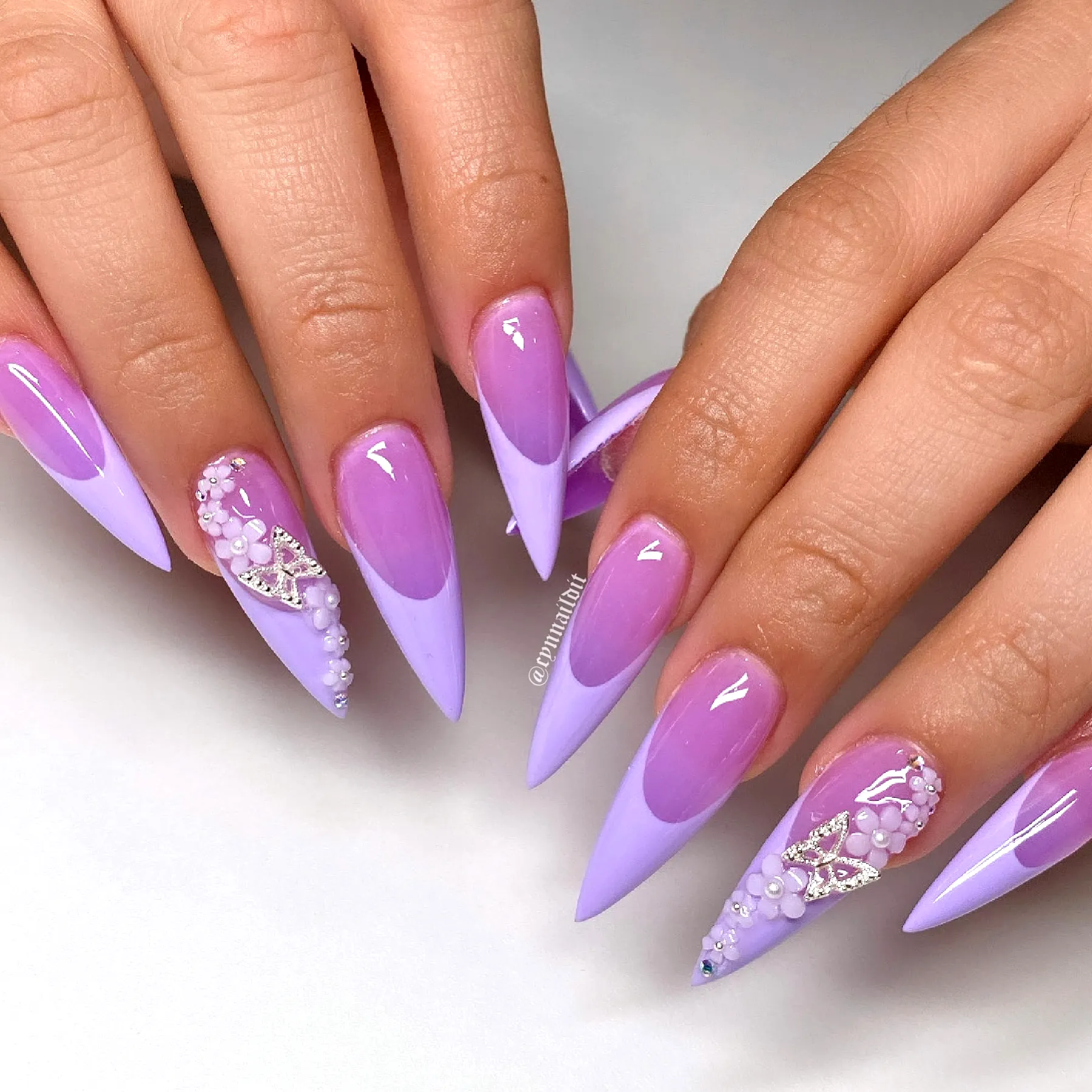 Exquisite Stiletto Purple Nails with Elegant Pearl and Gem Embellishments and Floral Nail Art