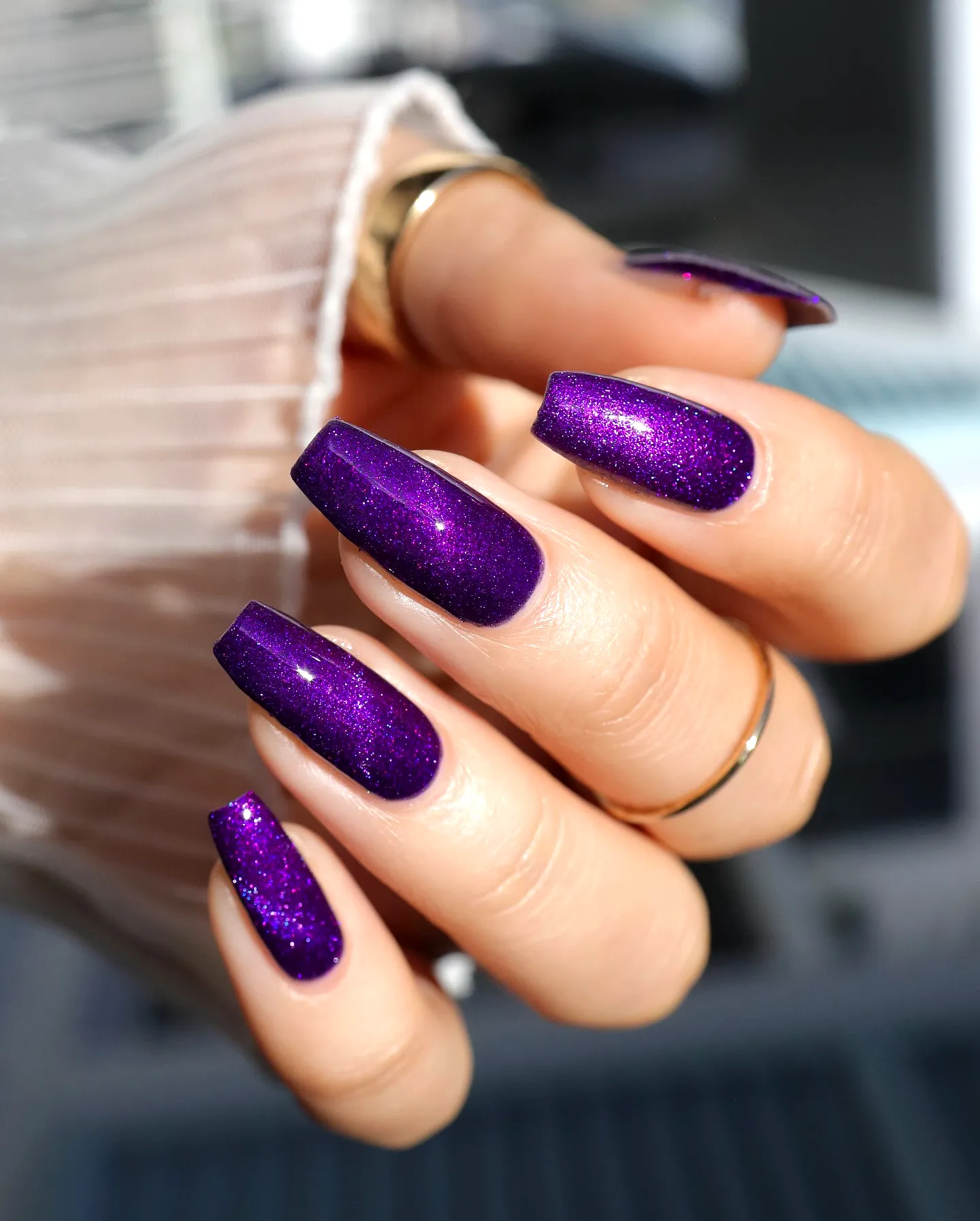 Glamorous coffin shaped purple nails with sparkling glitter finish