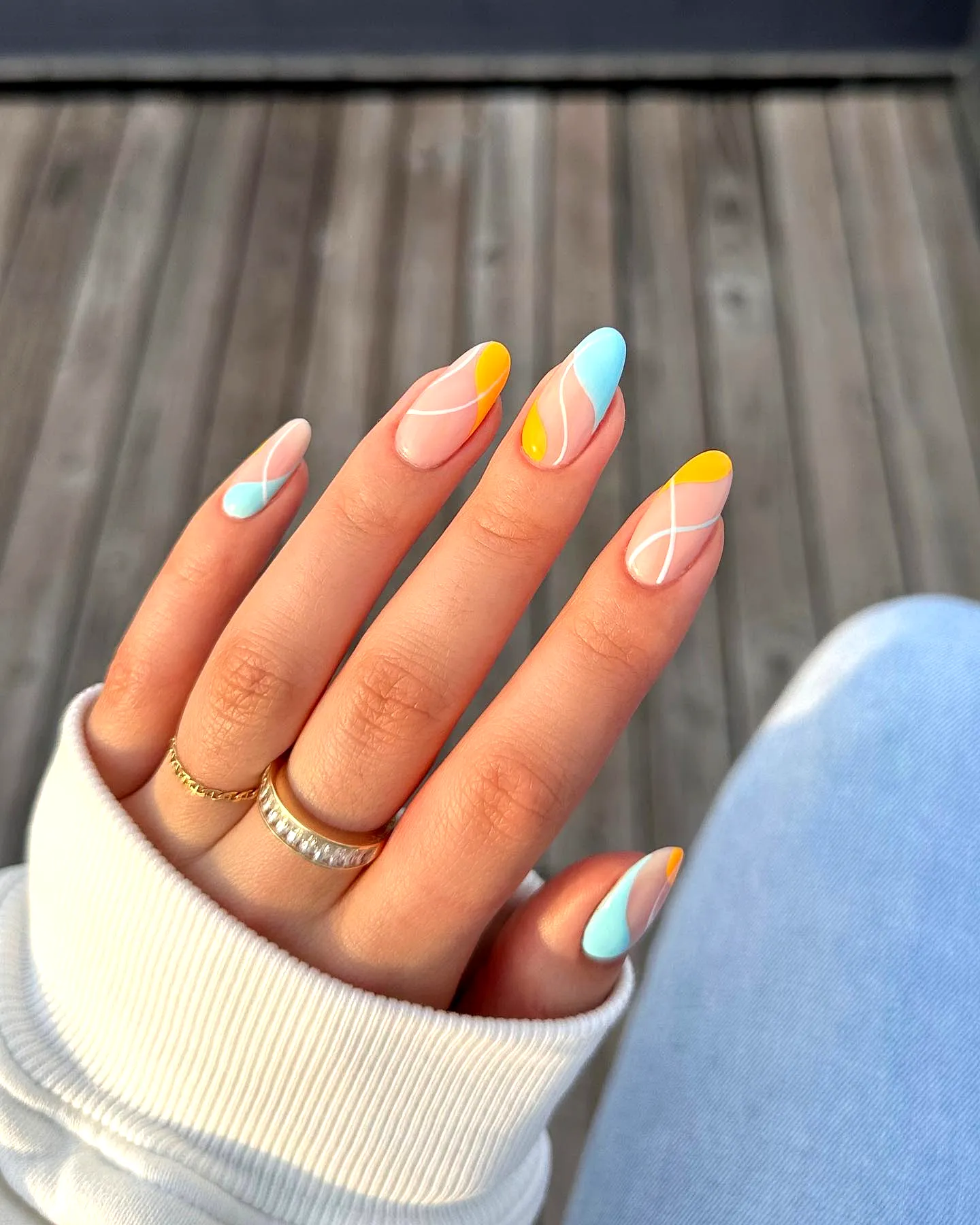 Playful Almond Shaped Summer Nail Designs in Pastel Colors with Wavy Patterns and Glossy Matte Finish