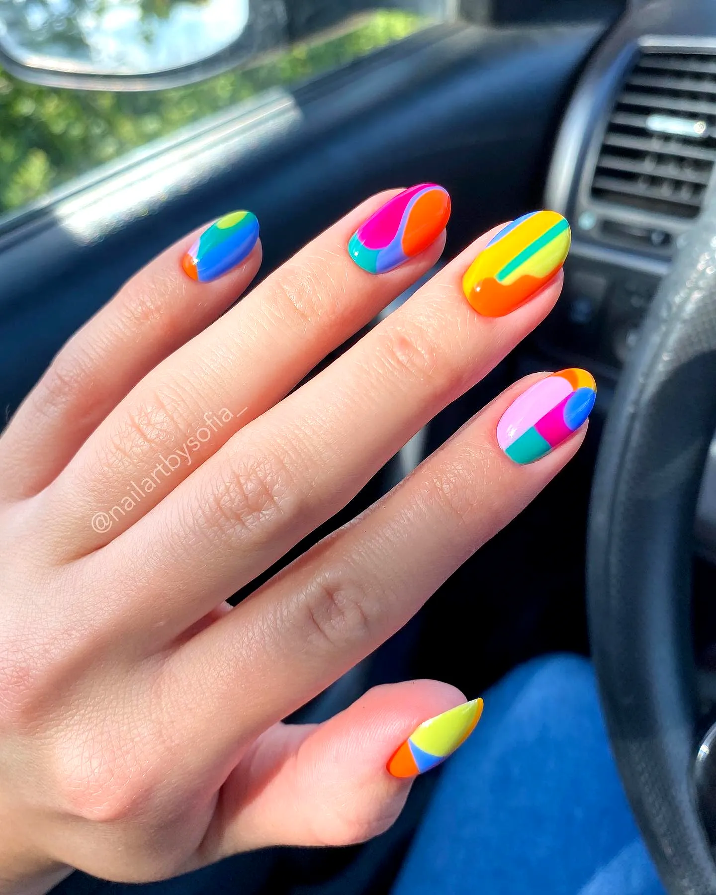 Playful Rounded Color Block Nails with Vibrant Colors and Abstract Patterns
