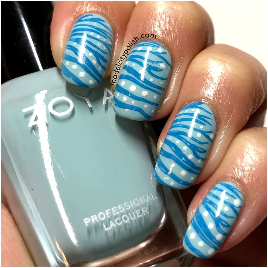 Playful Rounded Ocean-Inspired Travel-Inspired Nails with Soft Blue Base Wavy White Stripes and Dotted Accents