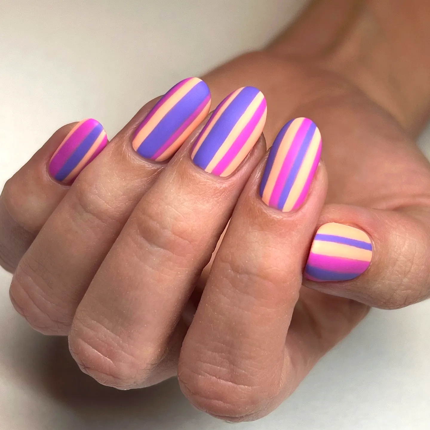 Striped Nails with Round Shape in Purple and Pastel Pink for a Fun Matte Design