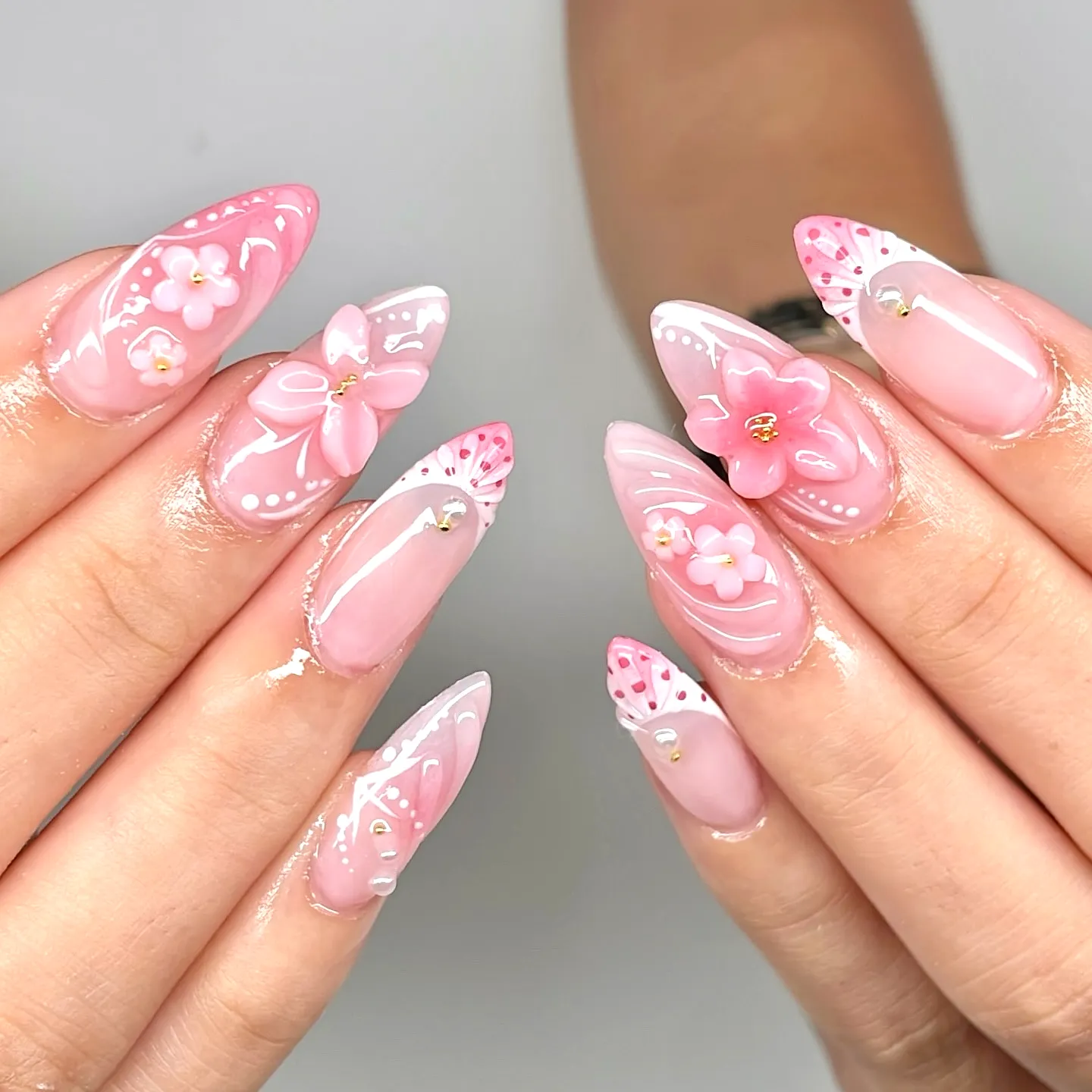 Stunning Almond Nails in Pastel Pink with 3D Floral Decorations and Elegant Patterns